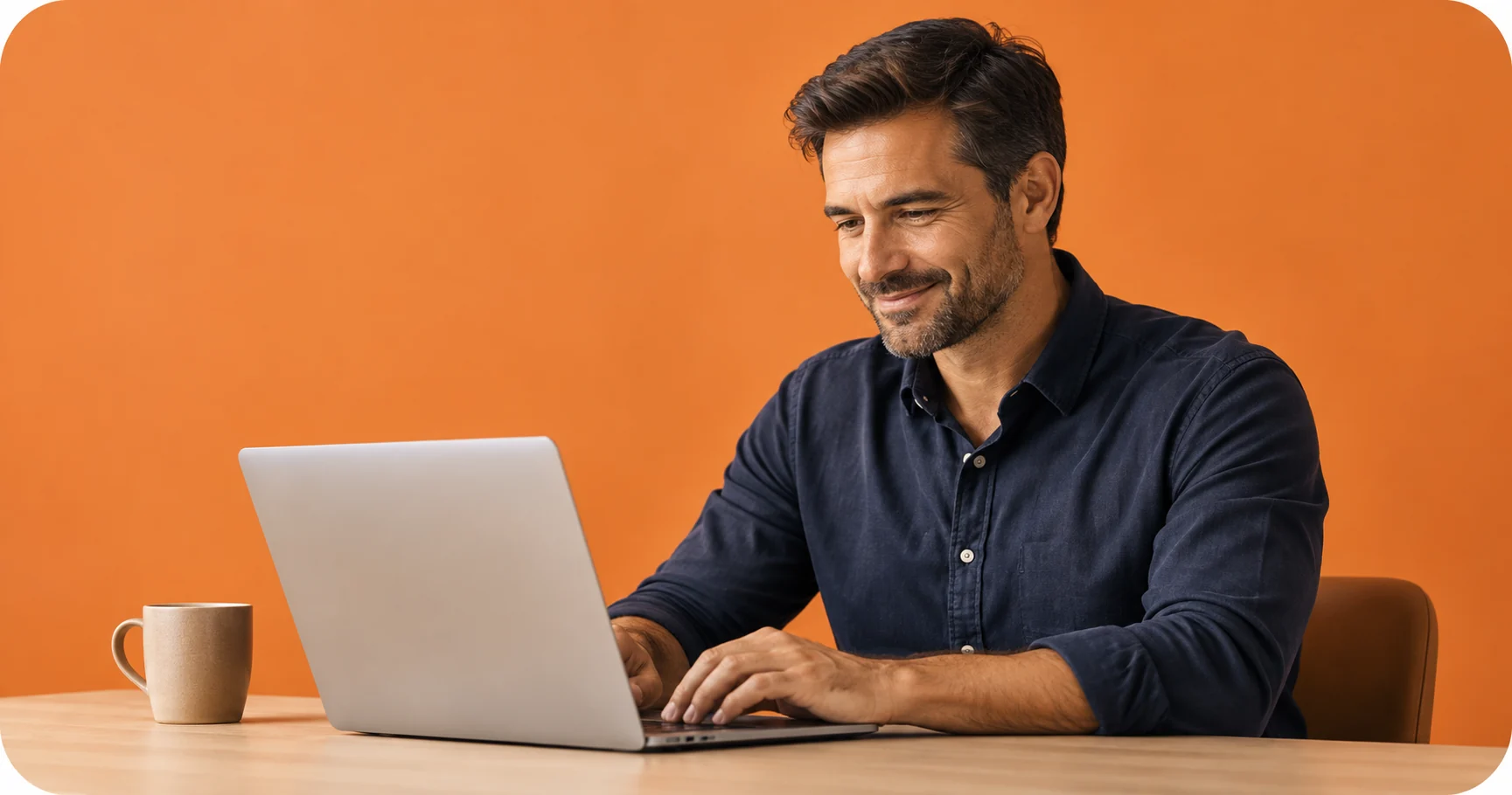 A relaxed investor reviewing his laptop at a desk against an orange background